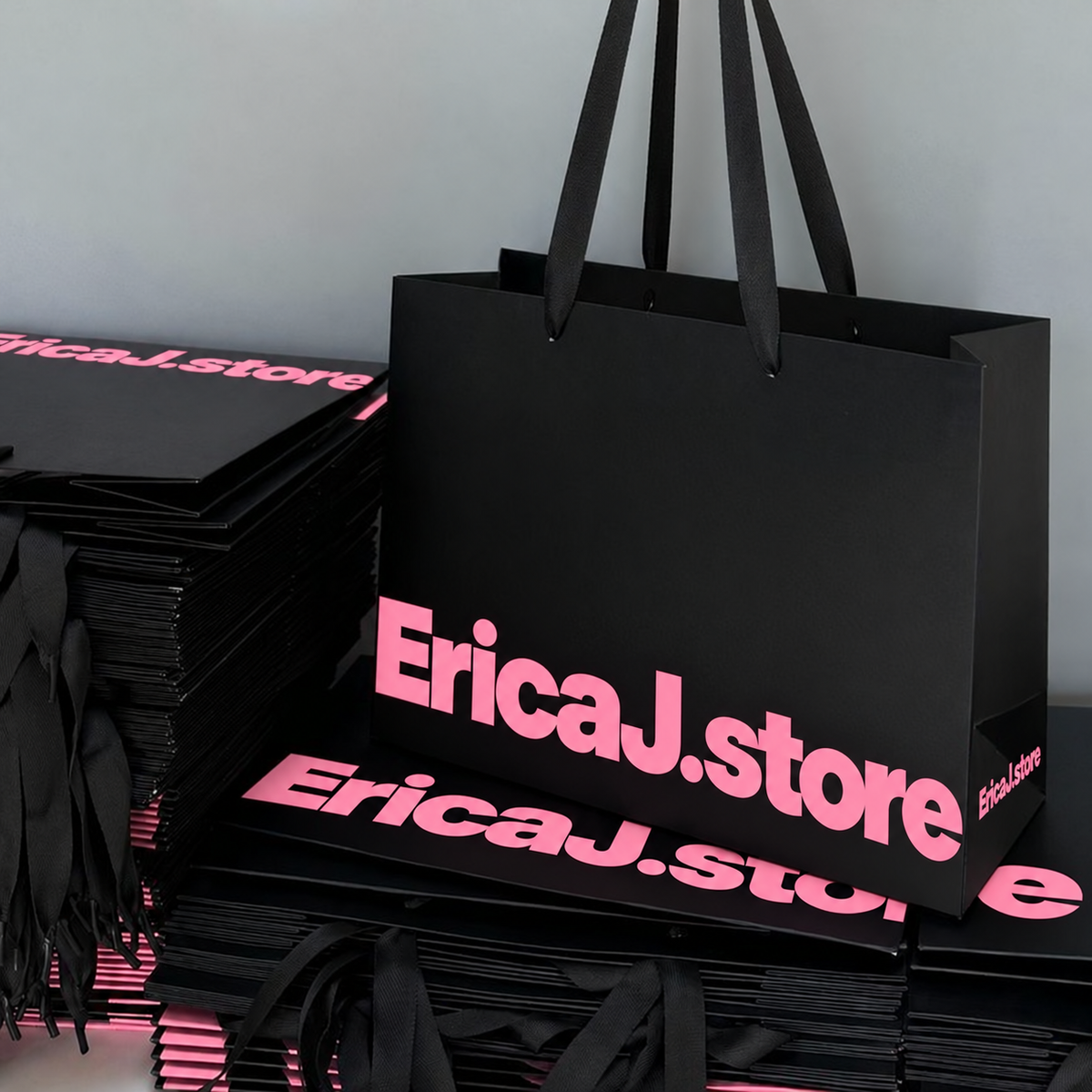 EricaJ.store black shopping bags with pink branding